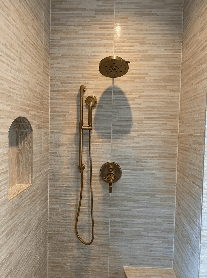 Brushed-brass shower with stacked-stone tile