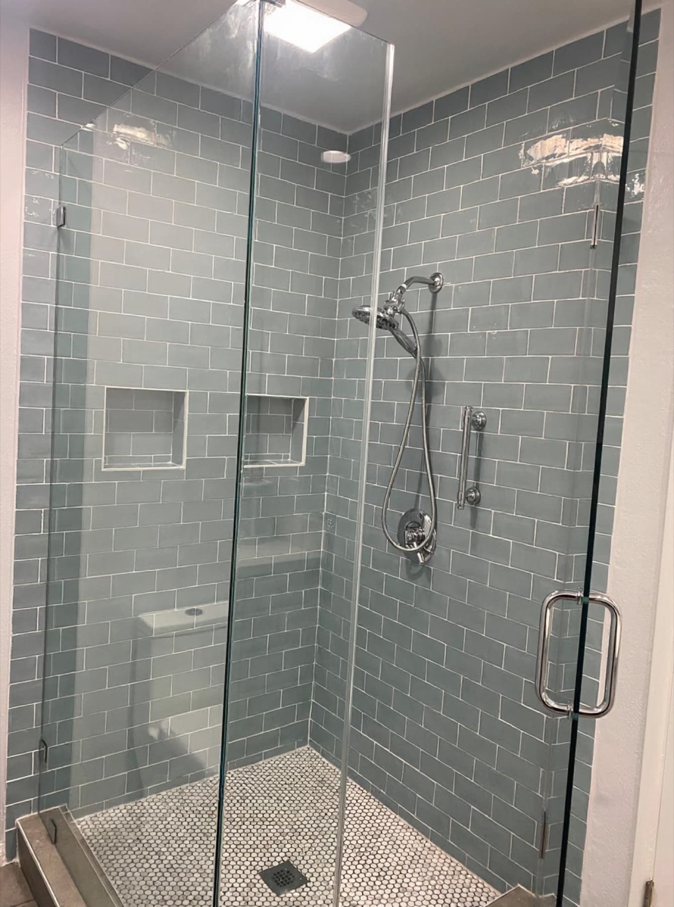 Seafoam subway shower with penny-mosaic floor