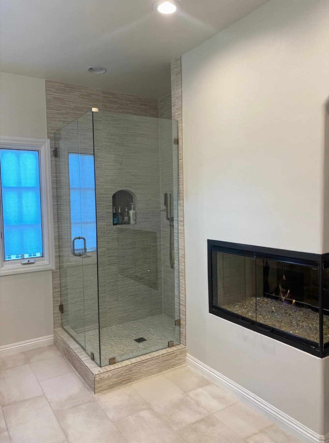 Spa shower next to a gas fireplace